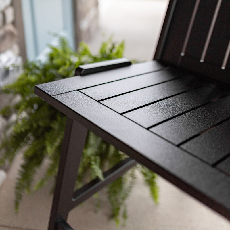 A close up of a black marine grade polyethylene dining chair