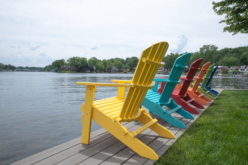 Side shot of Comfo Back Folding Adirondack Chairs in tropical colors in a line