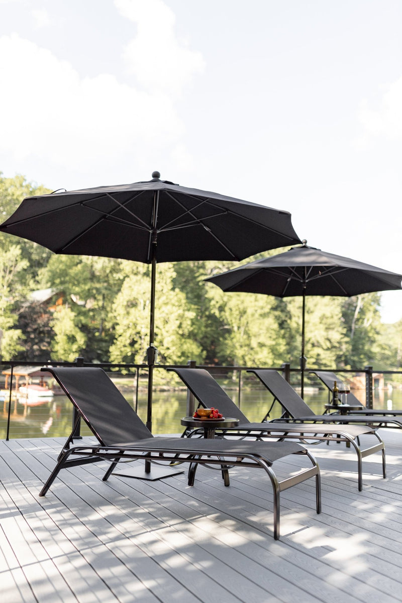 Murphy Chaise Lounges and Murphy End Tables in Black with sling in Augustine Ebony. Umbrellas in Canvas Black